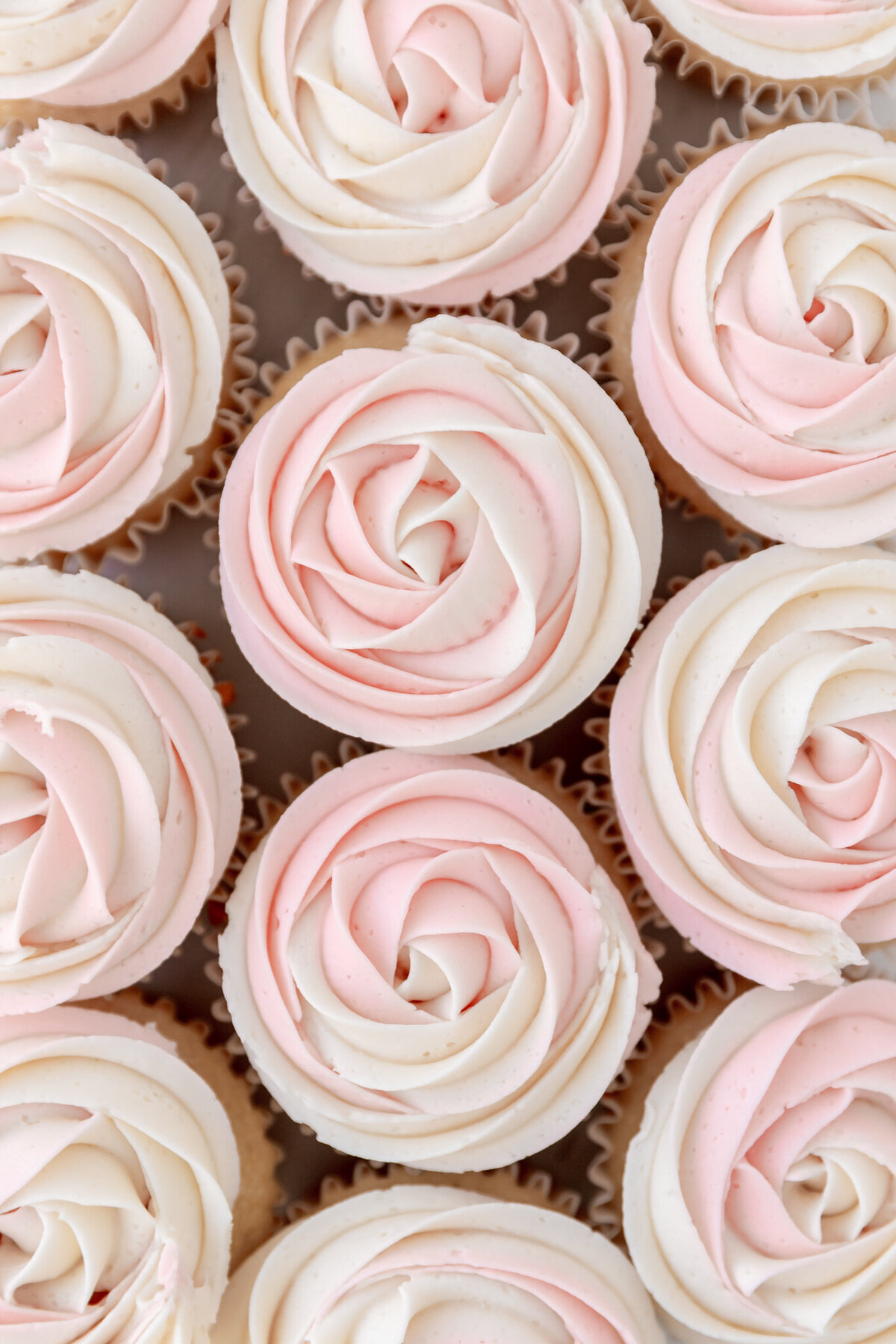cupcakes topped with pink and white frosting