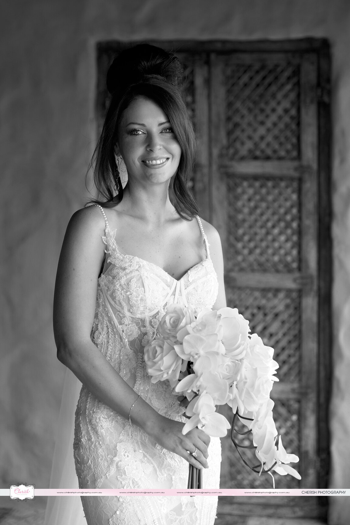 Elegant black and white bride portraits at Villa Botanica amidst blooming flowers.