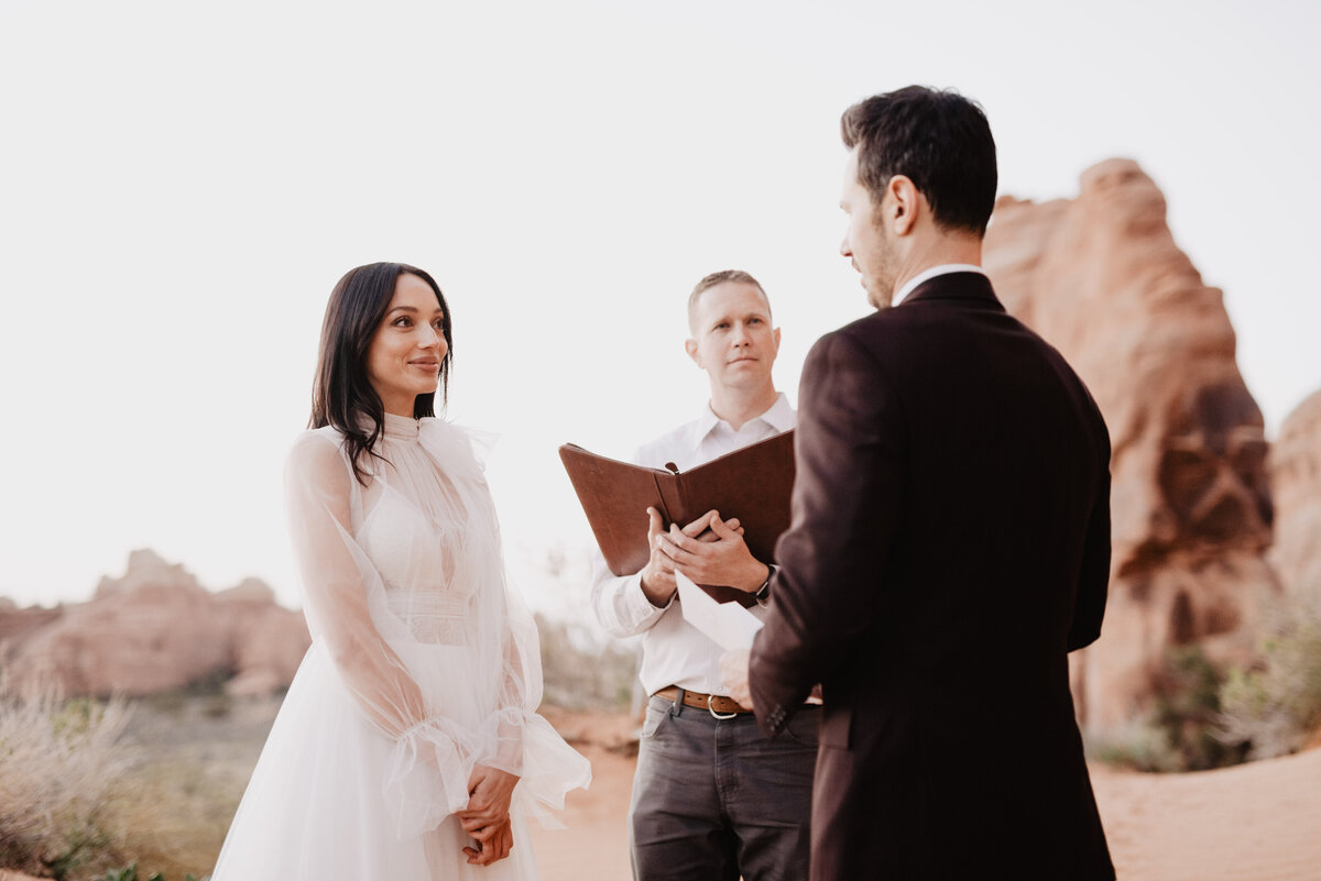 Utah elopement photographer captures groom looking at bride during vow ceremony