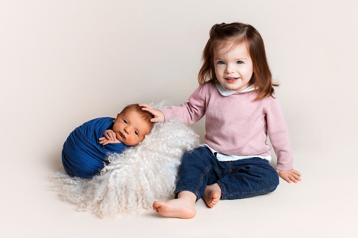 Newborn baby boy and toddler sister siblings photo