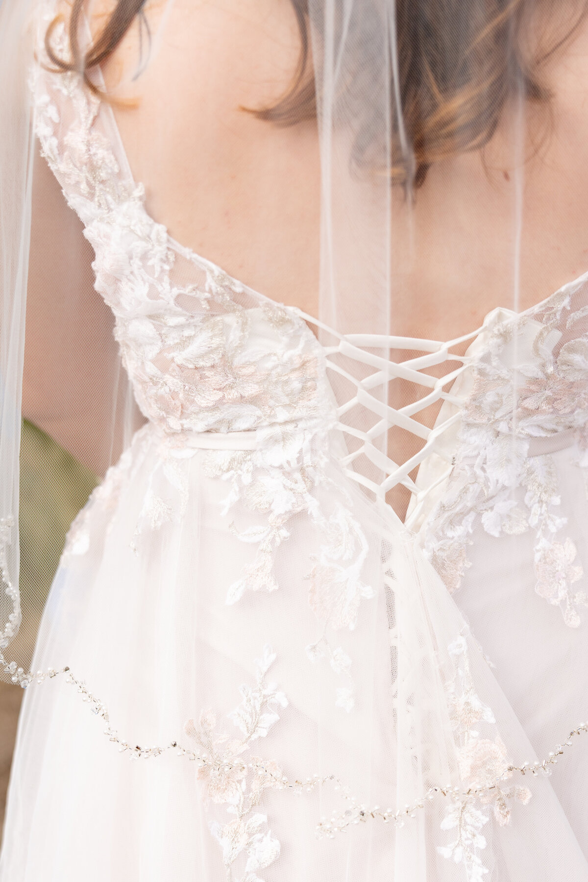 Beautiful detail shot of all the lace work on the backside of the brides dress.