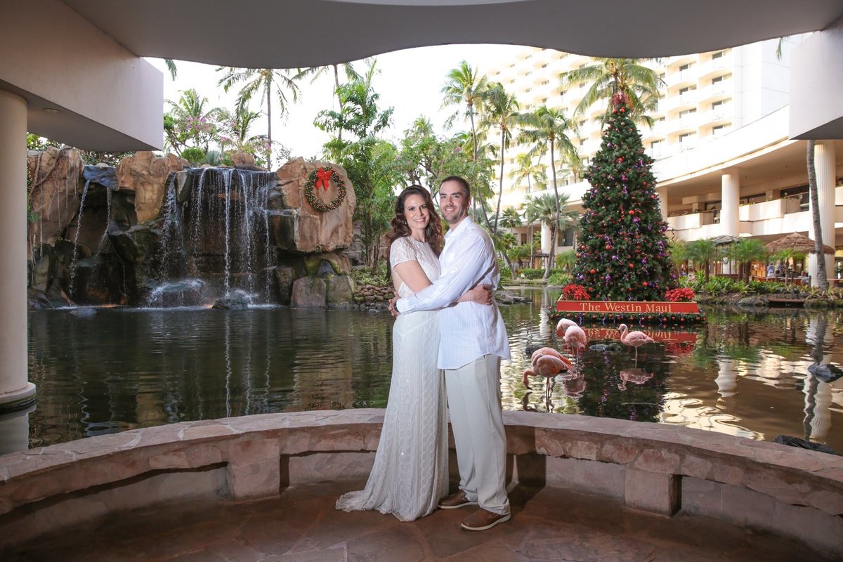 Wedding Photography at The Westin Maui Resort and Spa with bride and groom in the lobby in front of the waterfall