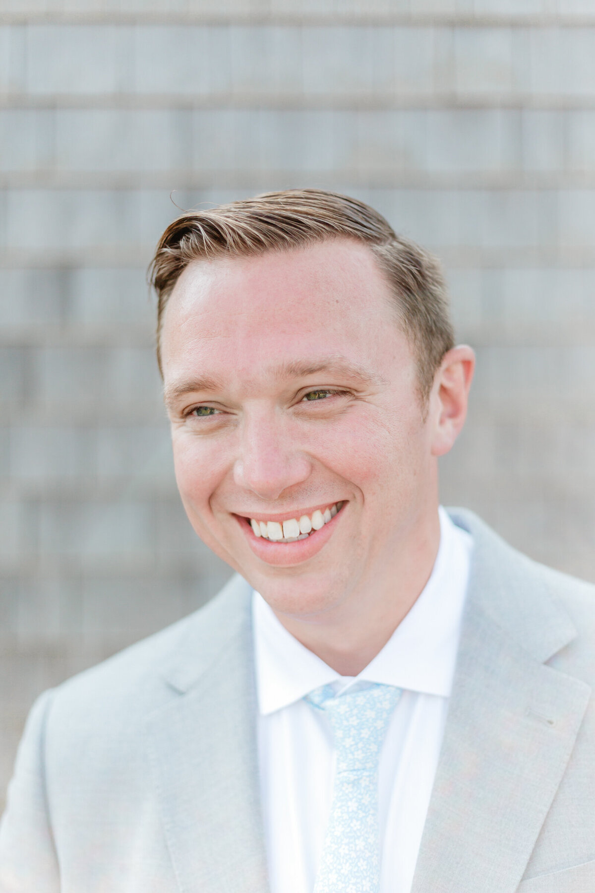 Groom in a light gray suit and light blue tie