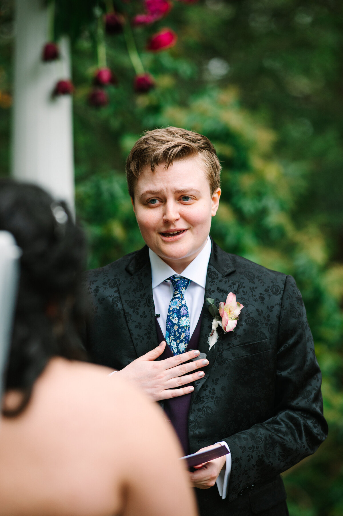 Bride in suit sharing her vows