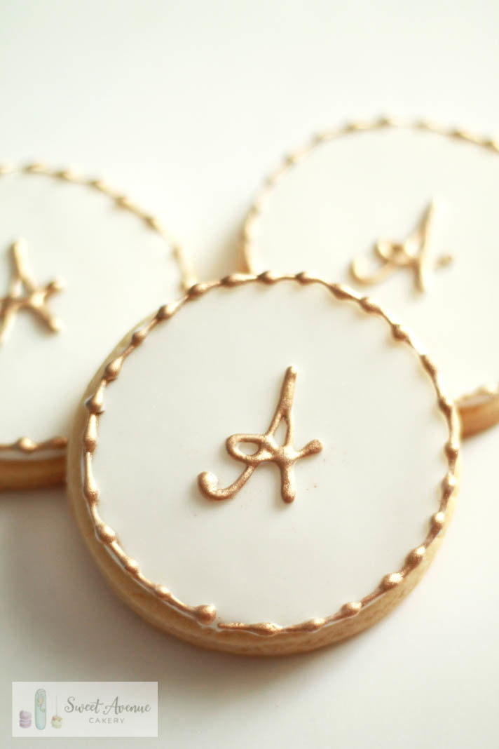 white and gold monogram cookies