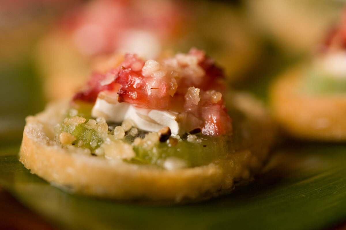 Crisp appetizer with bacon and cheese on cracker