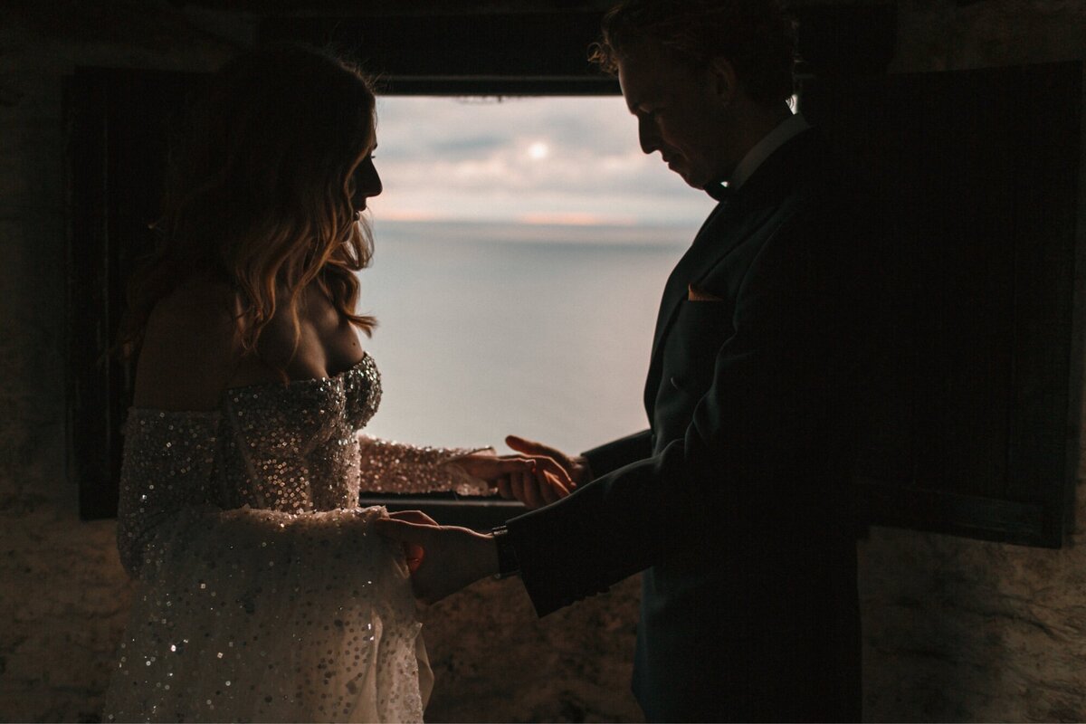 Couple chat semi silhouetted against setting sun 