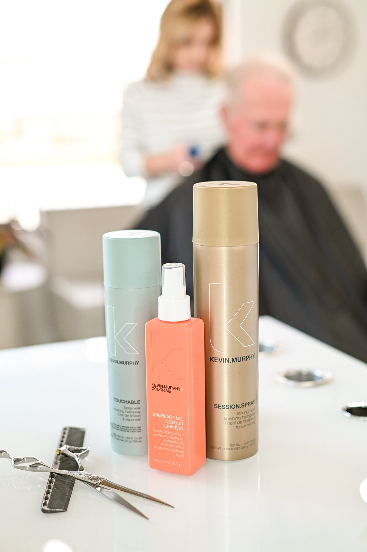 Keith murphy products in use on silver haired man during haircut