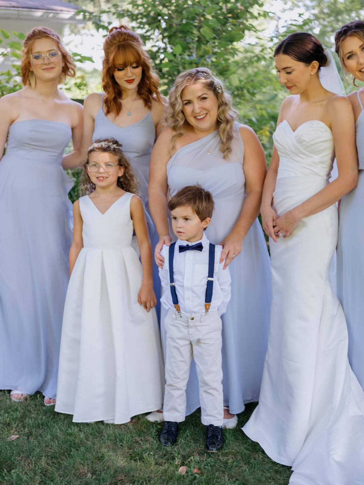 Bride in Maggie Sottero gown with bridesmaids in blue Birdy Grey dresses.