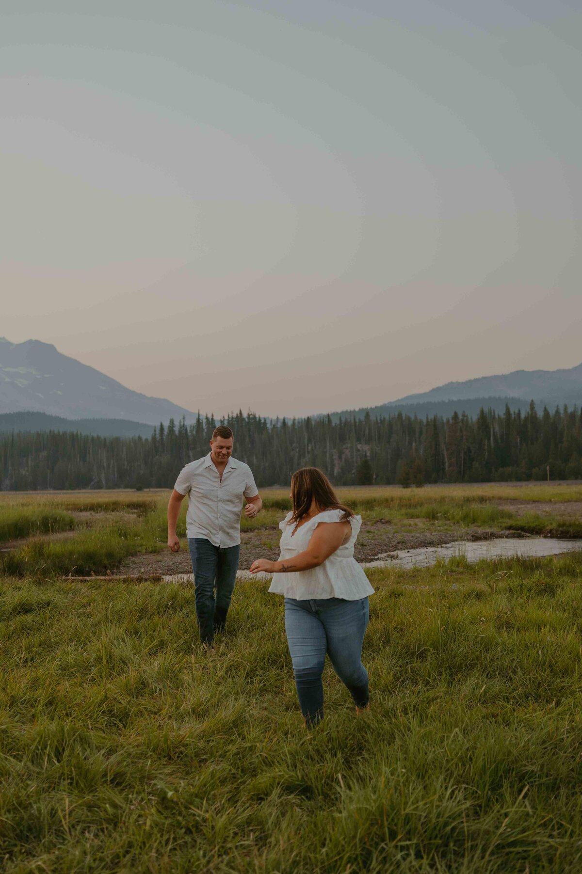 couple chases each other while enjoying the sunset
