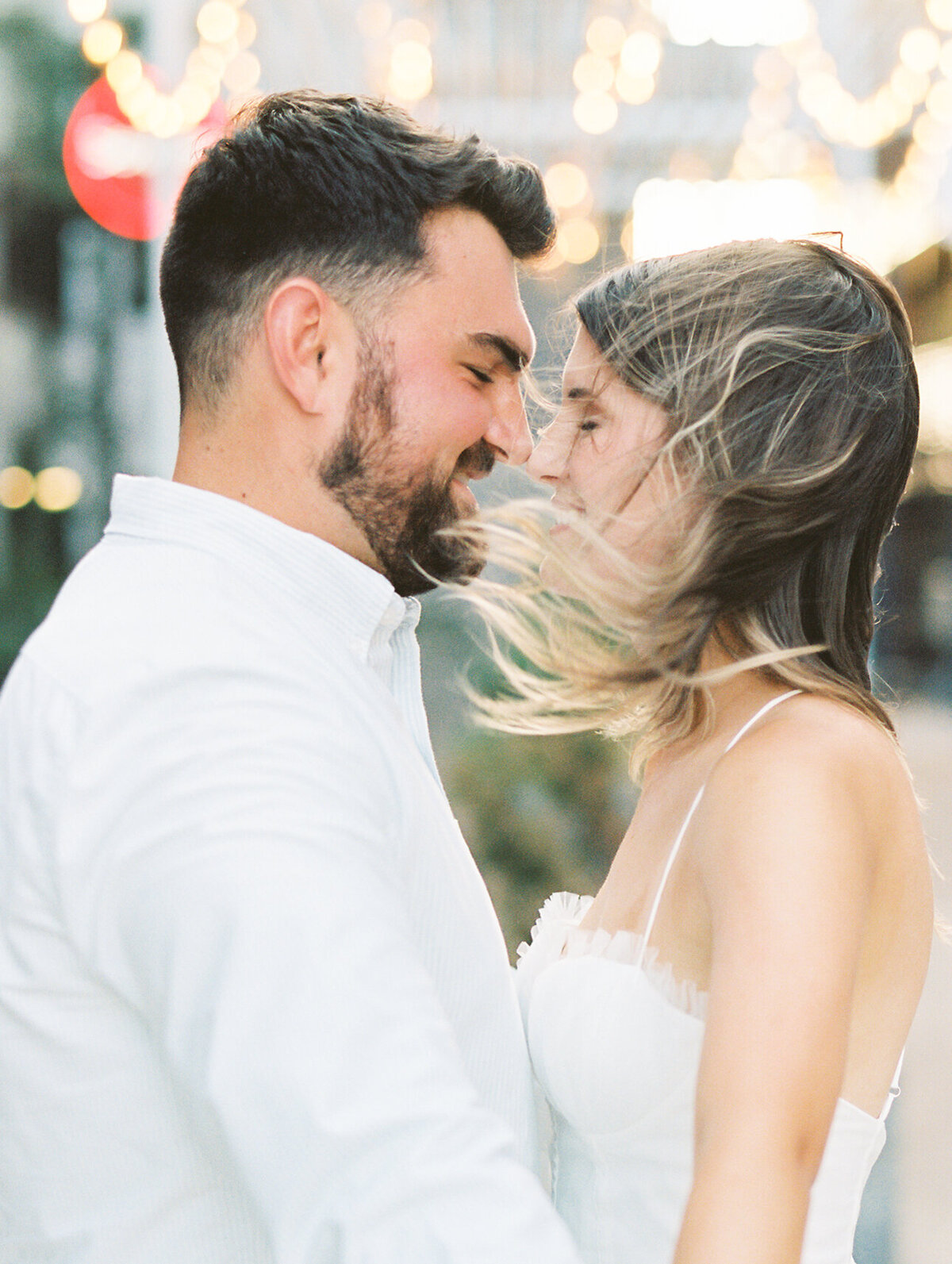 Close up of man and woman with their heads together with hair blowing in the wind