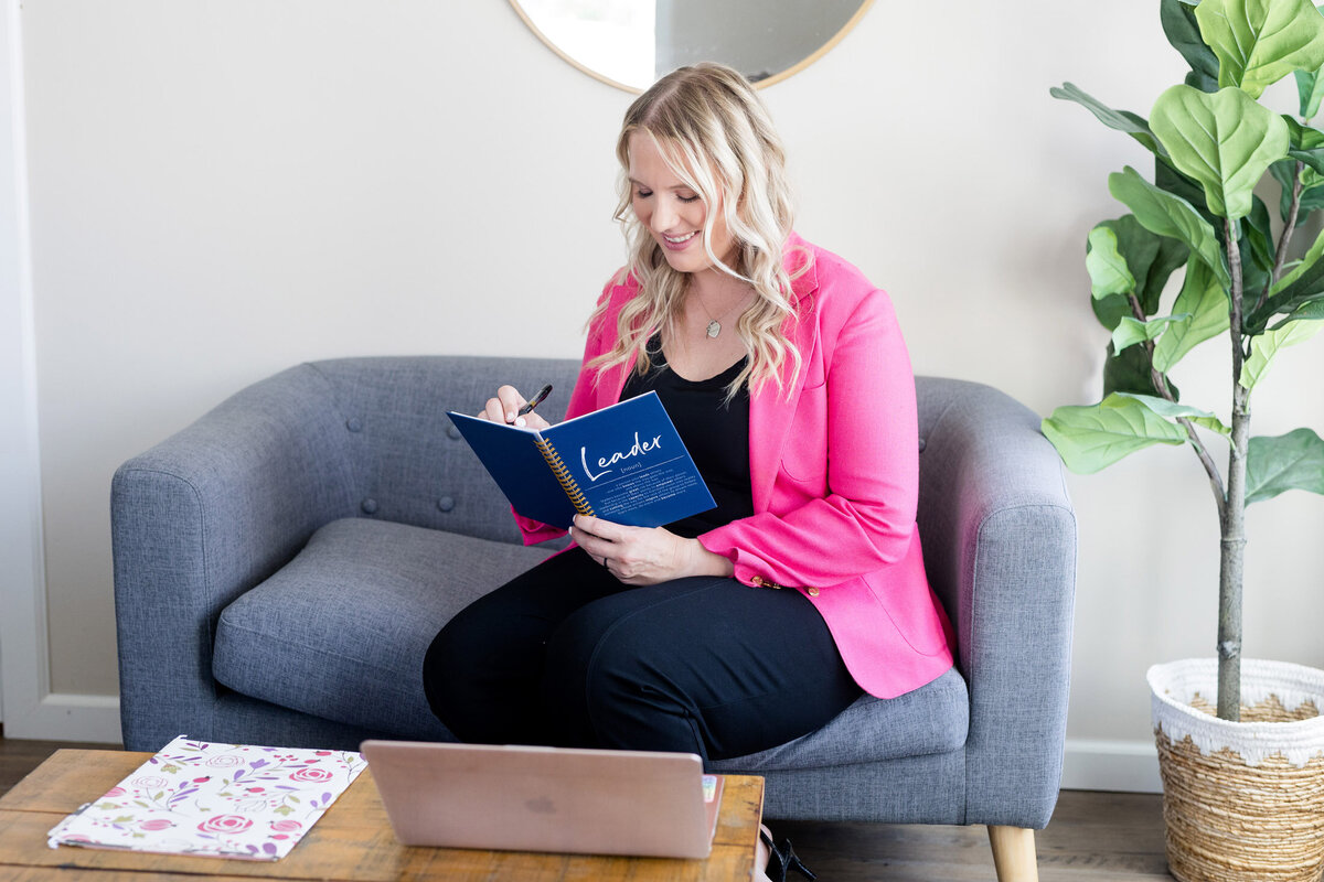Becca sitting on a couch with a book