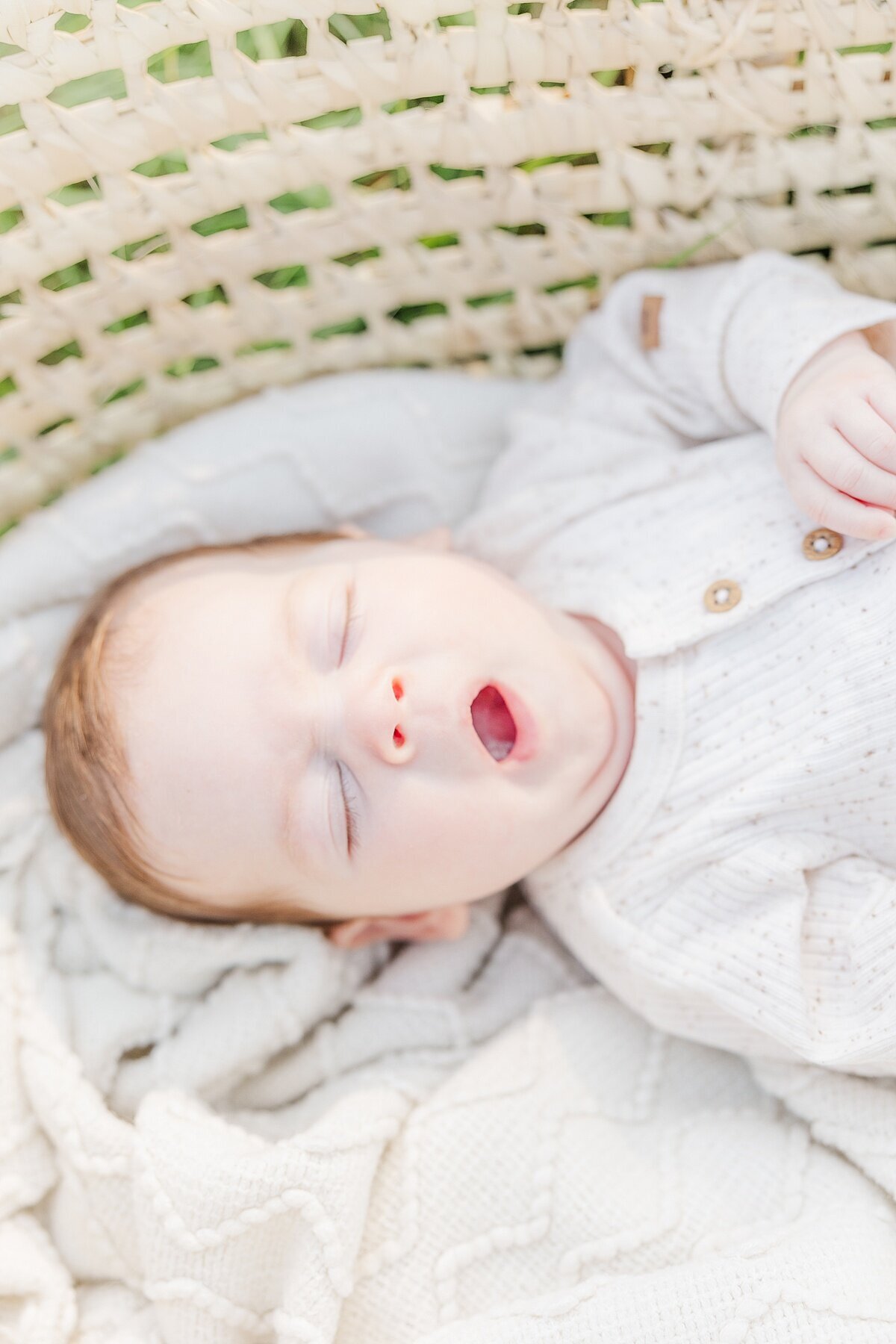 baby yawns during outdoor newborn photo session in Natick Massachusetts with Sara Sniderman Photography