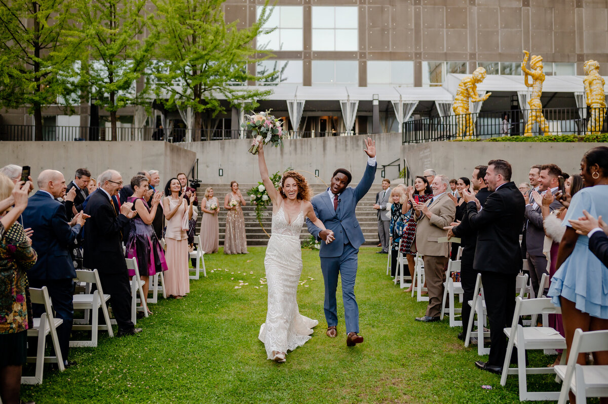 A bride and groom celebrate after getting married at the MCA in Chicago, Illinois