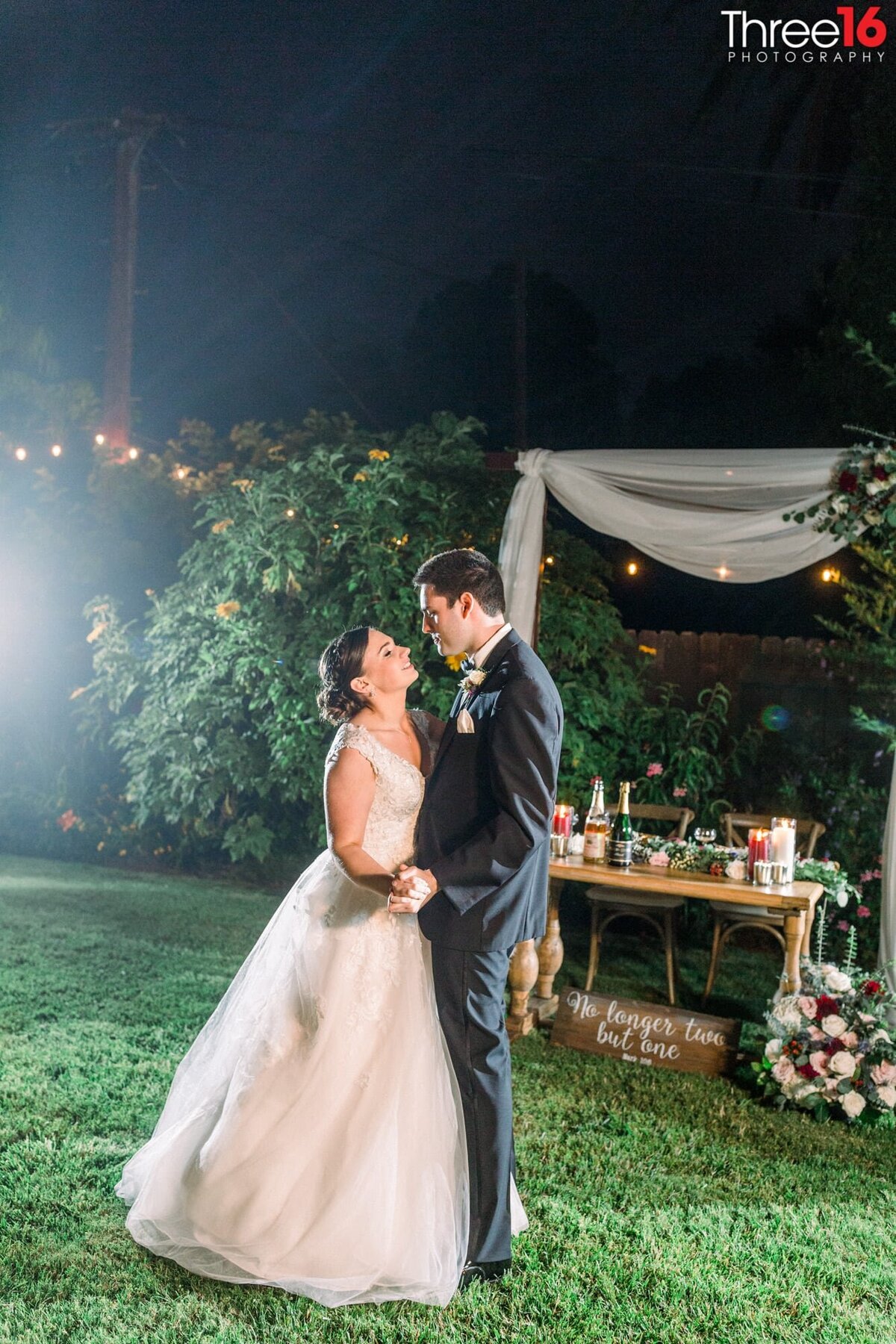 Bride and Groom share a dance in a rustic ceremony setup