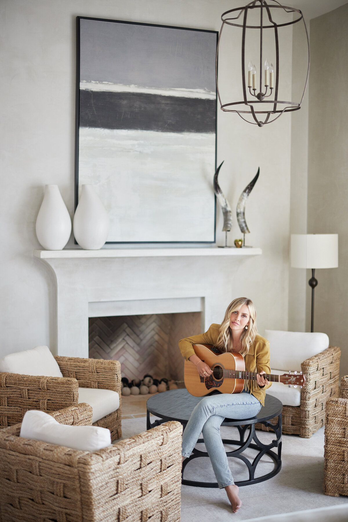 A woman sitting on a coffee table playing guitar