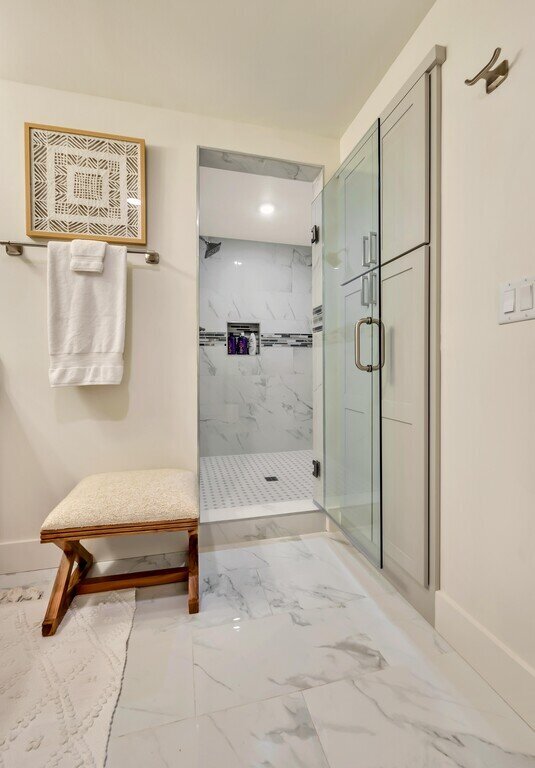 Bathroom with large walk in shower in this 2 bedroom, 2.5 bathroom luxury vacation rental loft condo for 8 guests with incredible downtown views, free parking, free wifi and professional decor in downtown Waco, TX.