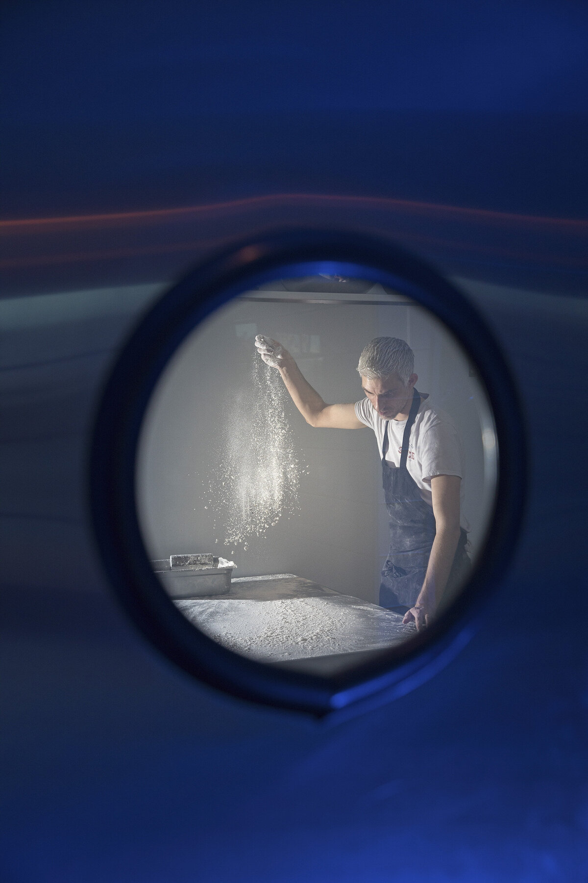 A chef cooking from behind a door