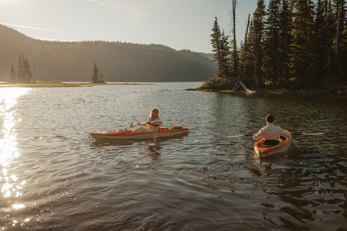 adventurous elopement couple go kayaking on Sparks Lake during sunset