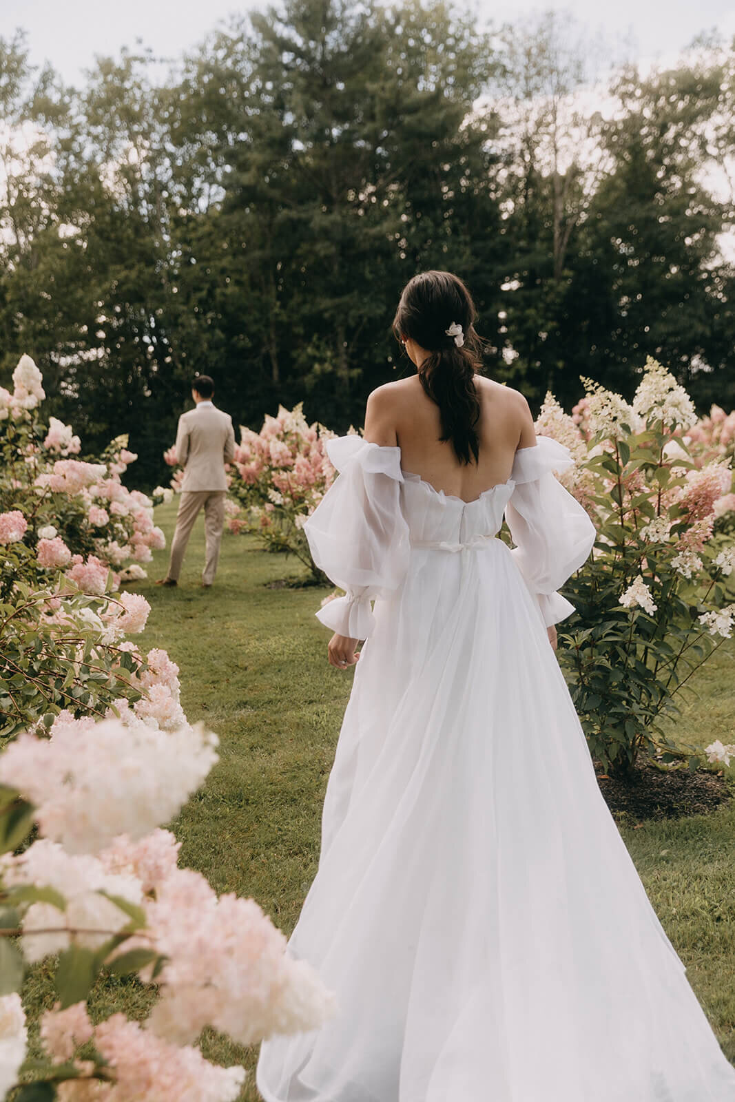 11. bride-walking-garden-white-wedding-dress-pink-hydrangeas