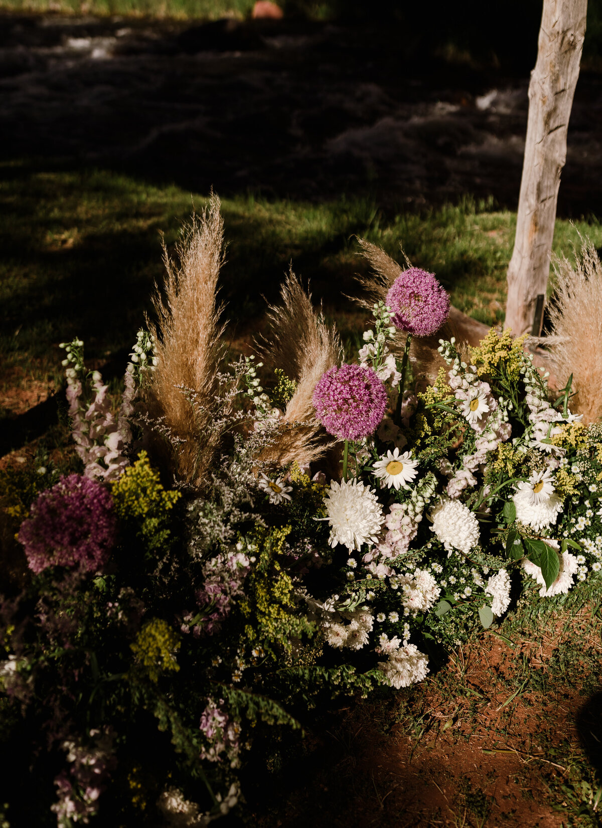 Florals arrangements on the ground at Dallenbach Ranch Colorado Wedding