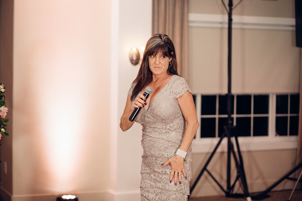 Wedding Photograph Of Woman In Light Brown Dress Speaking In Microphone Los Angeles