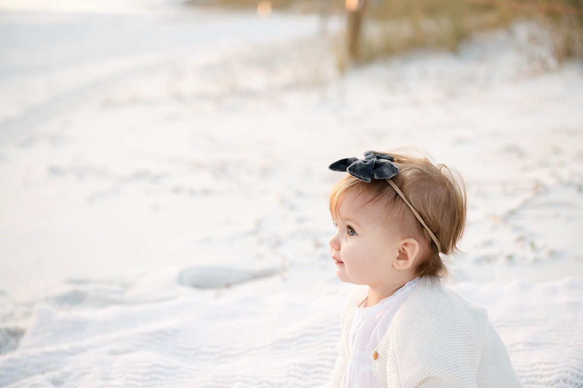 a little girl at a destin beach with photographer