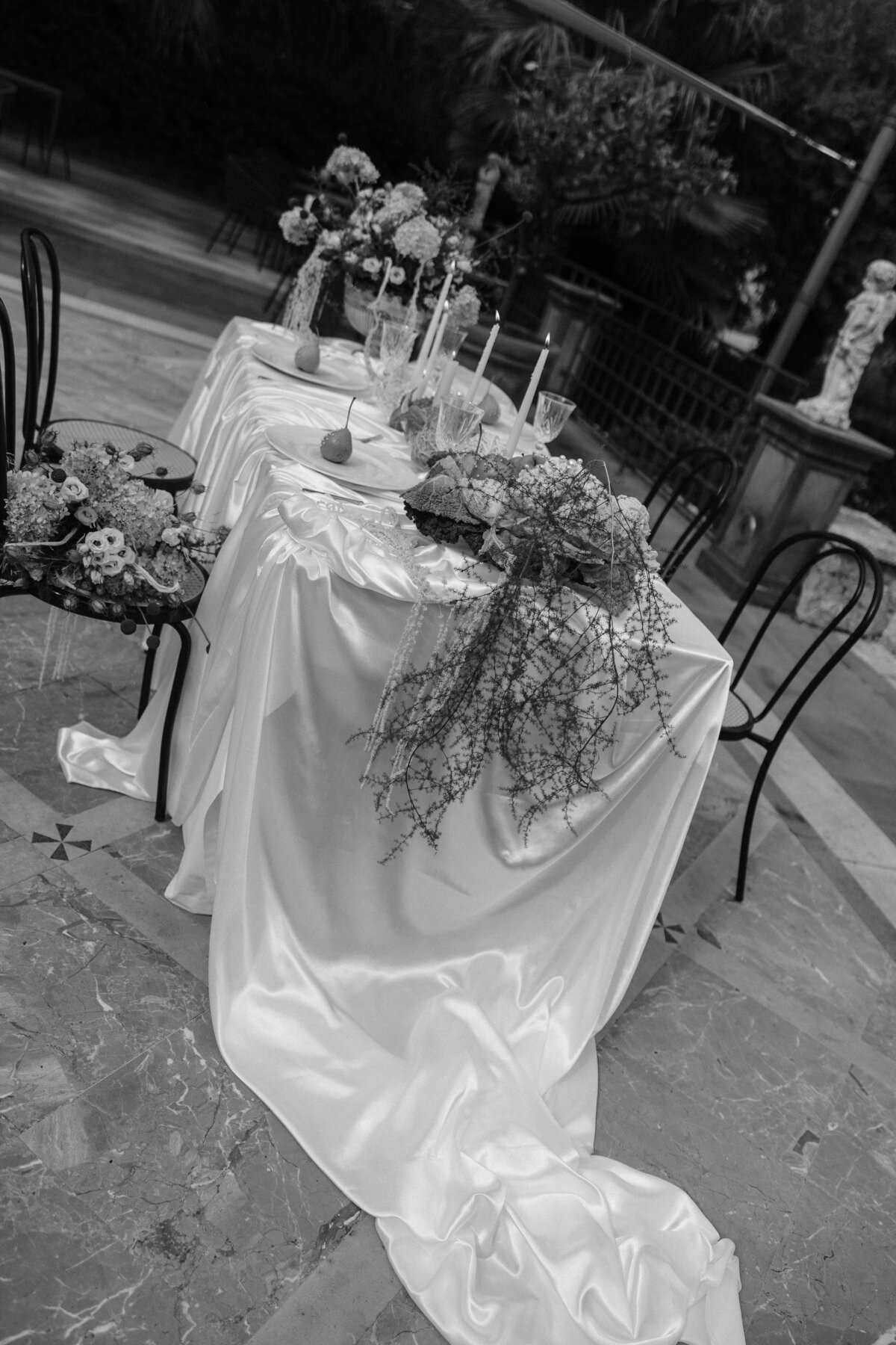 black and white photo of intimate ceremony table with white satin drapery