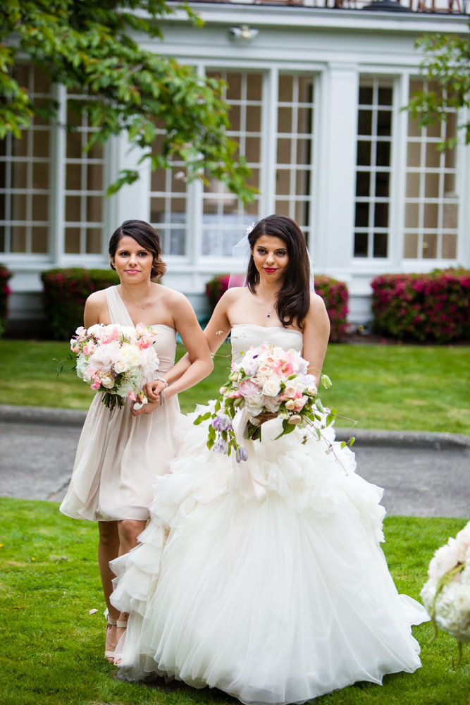 Lovely bride at her outdoor spring garden wedding ceremony featuring blush peonies.