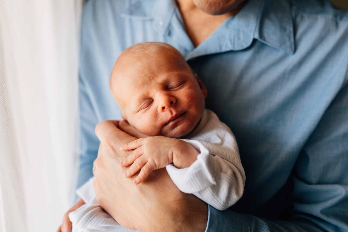 Baby facing camera, held in arms. Family Photography Gift Vouchers Melbourne