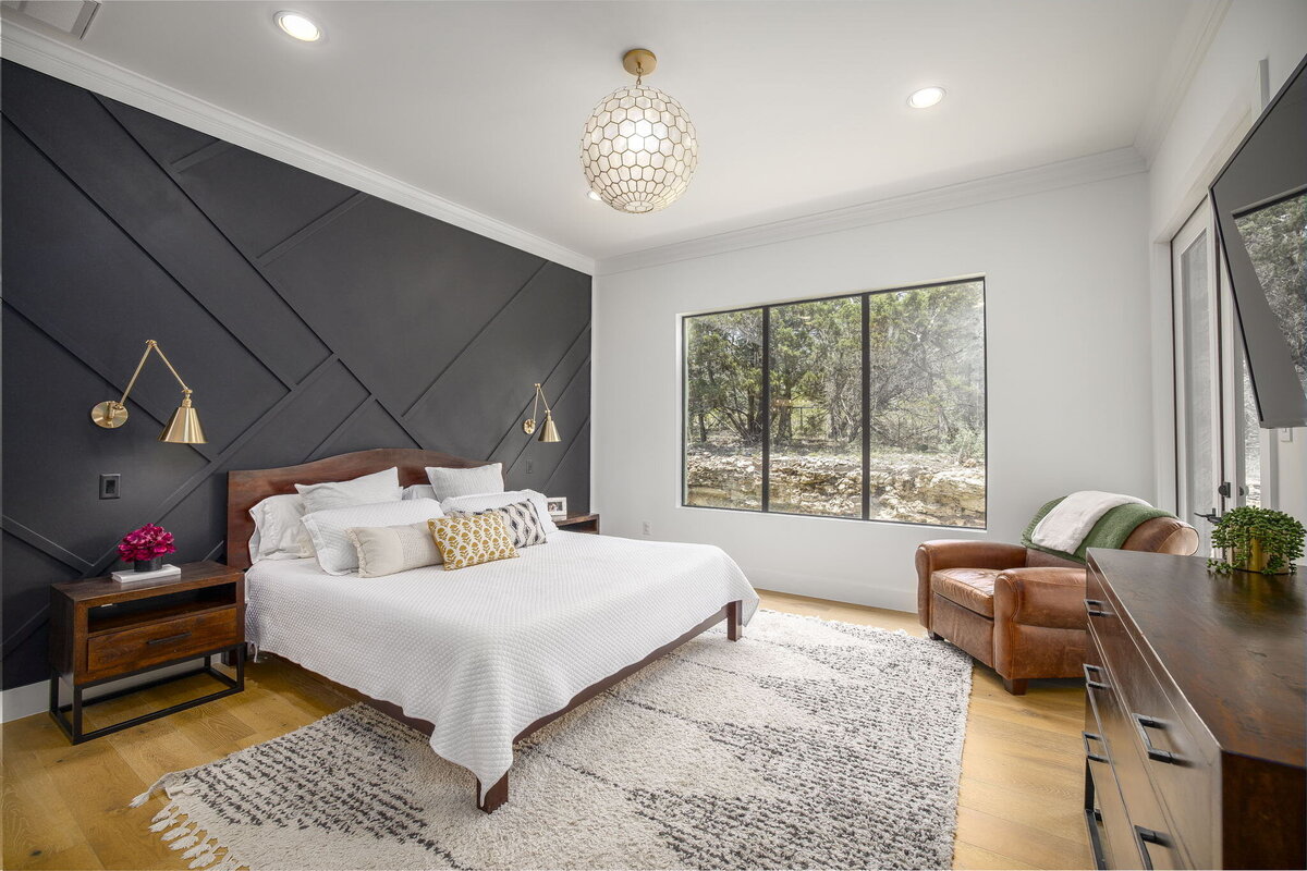 modern angled black feature wall in main bedroom with pendant light fixture