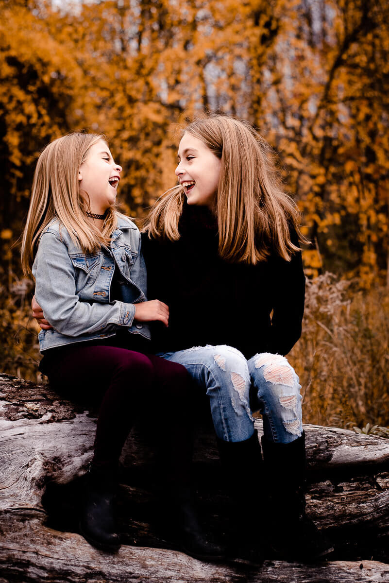 Sisters sharing a laugh during Toronto family photography session