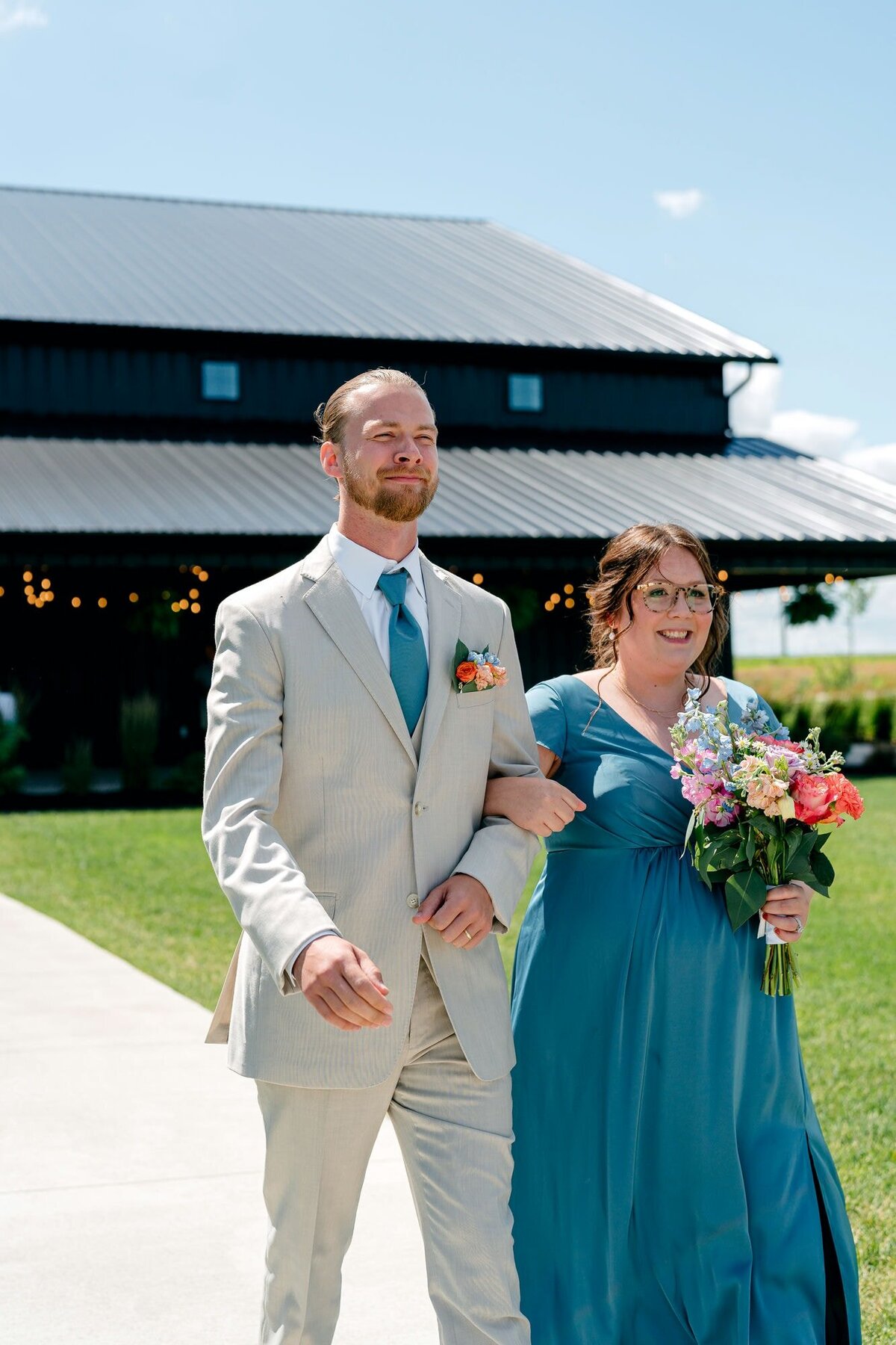 wedding-party-smiling-down-ceremony-aisle