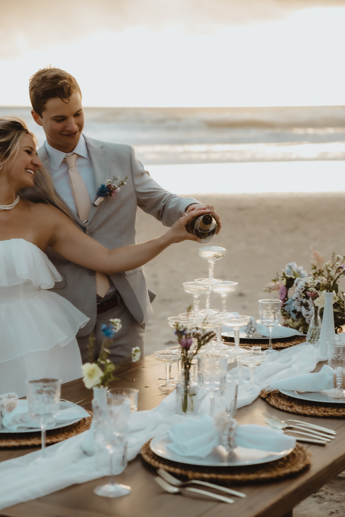 TABLESCAPE WITH BRIDE AND GROOM ON BEACH