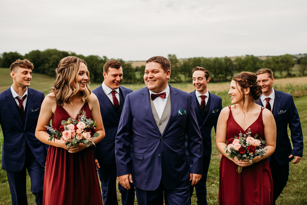 Groom and wedding party smiling at each other