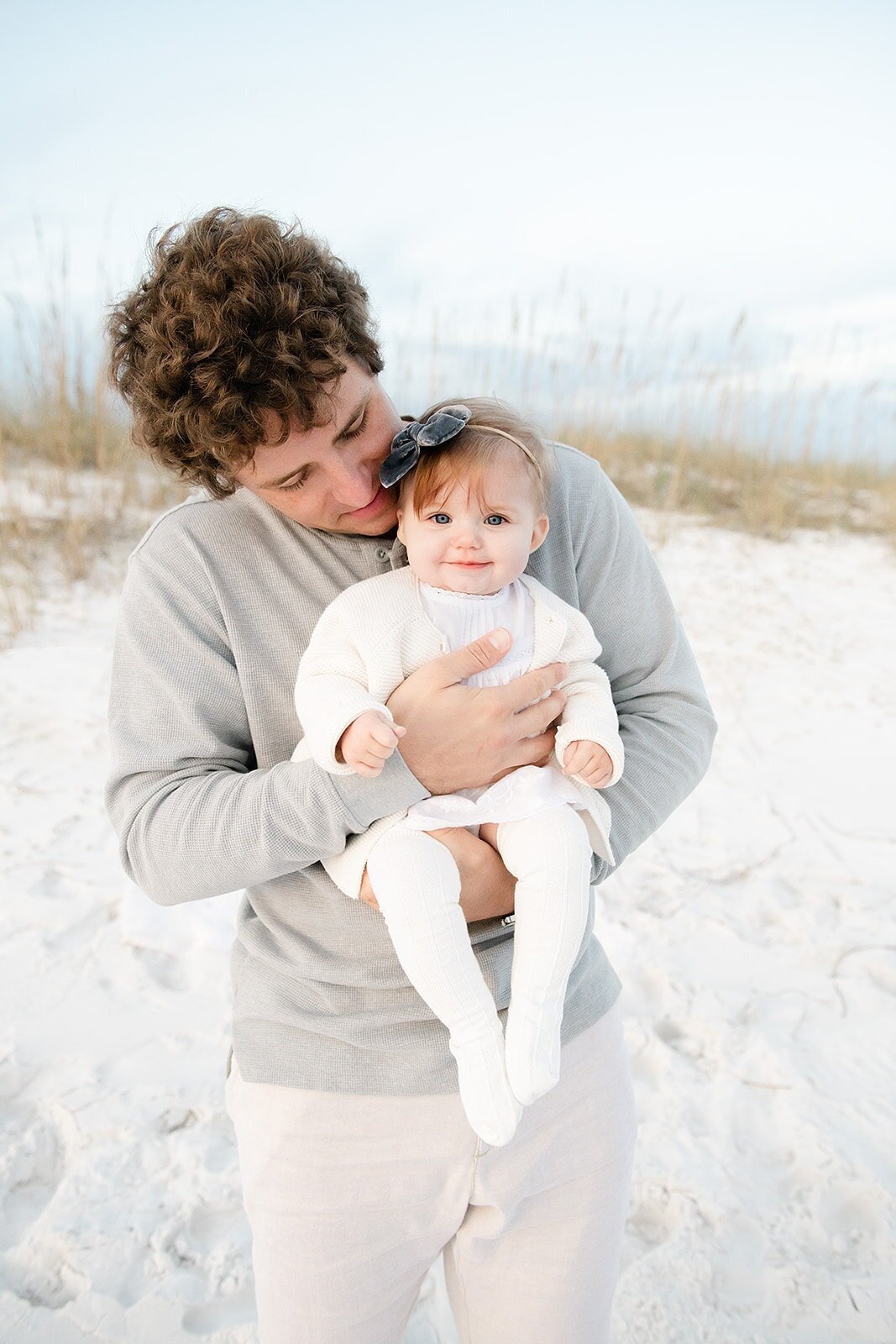 a father holding his baby when photographed by destin family beach photographer