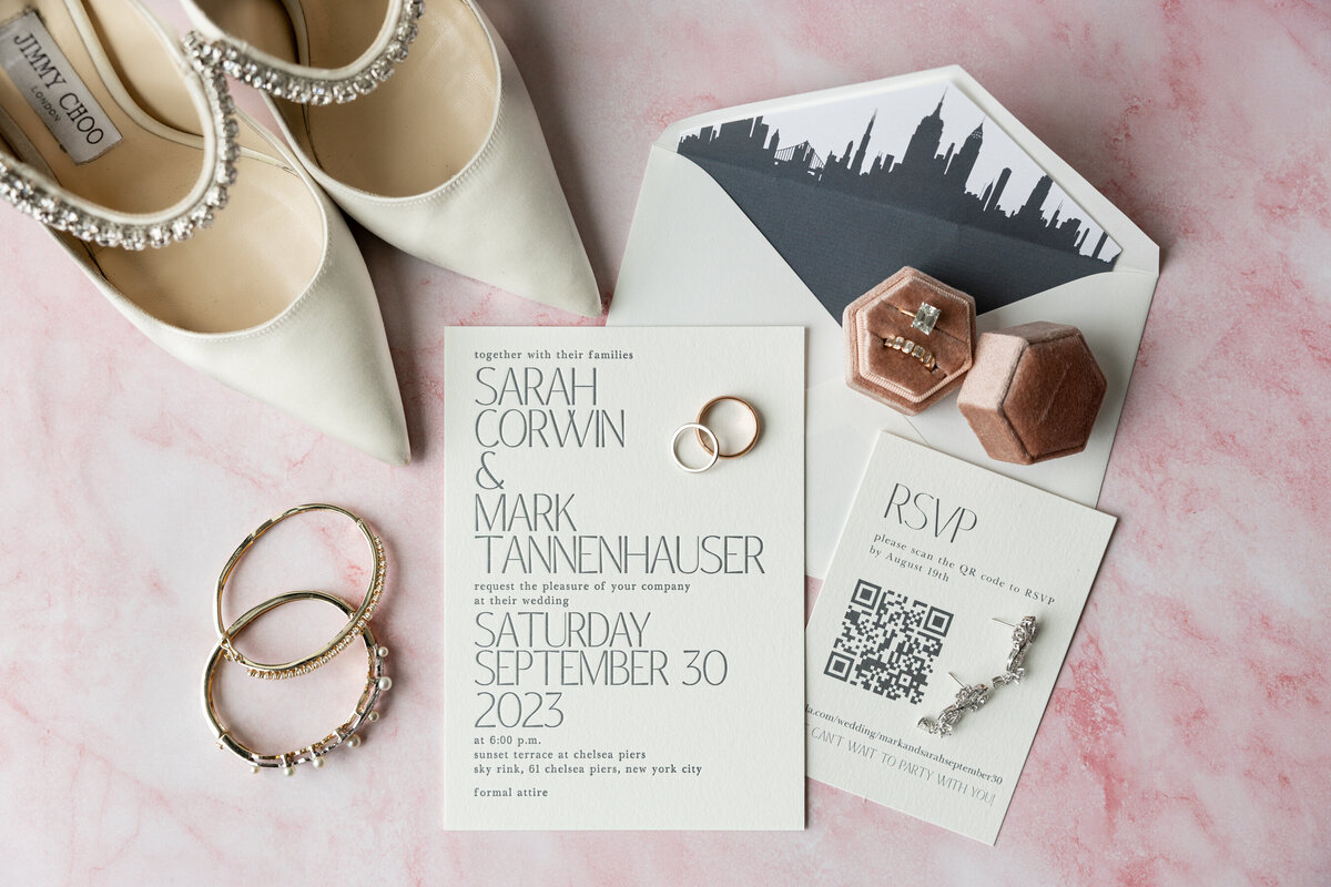 a flatlay of Sarah's wedding details and invitation