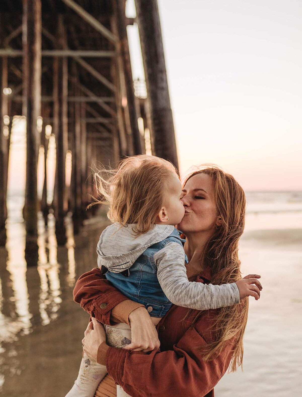 Momma kissing her baby girl