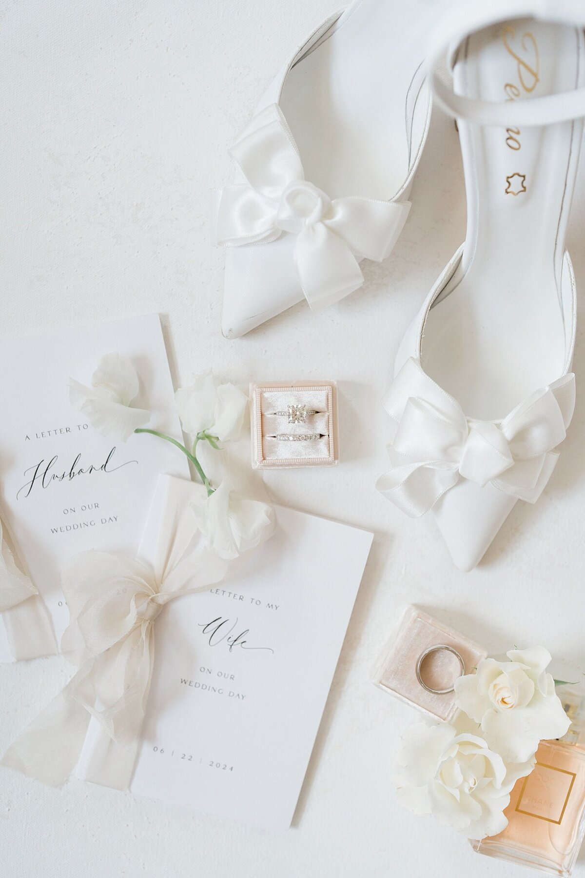 detail photos of vow books, bridal shoes and florals