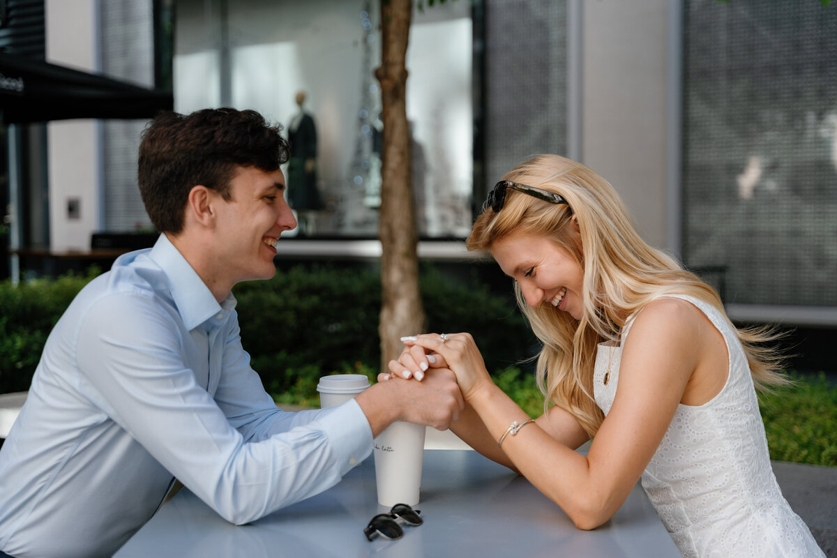 A couple holding hands over a table