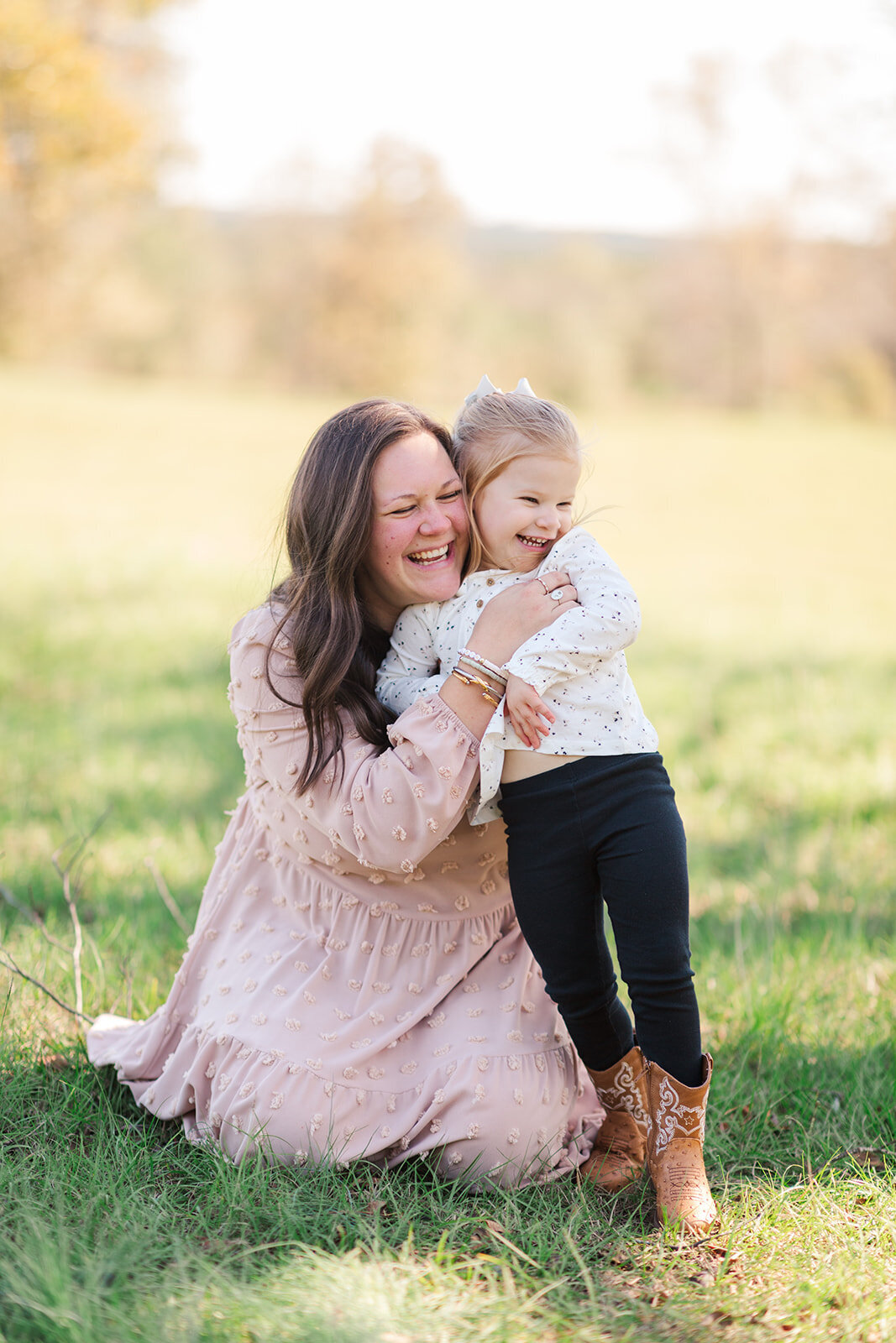 Parents smiling with newborn and toddler during session