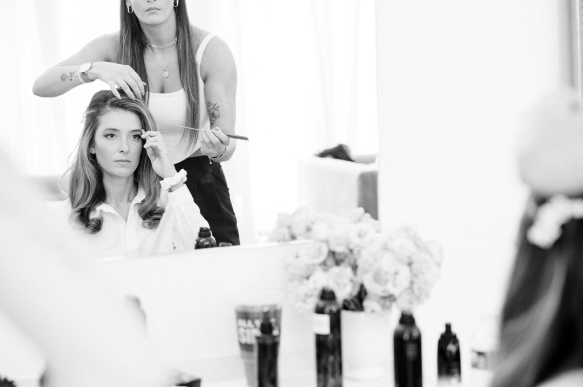 a bride getting her makeup done for her wedding