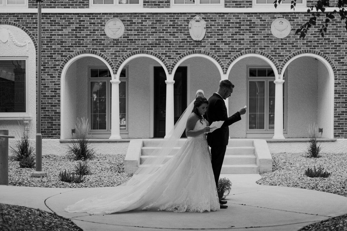 bride and groom reading private vows