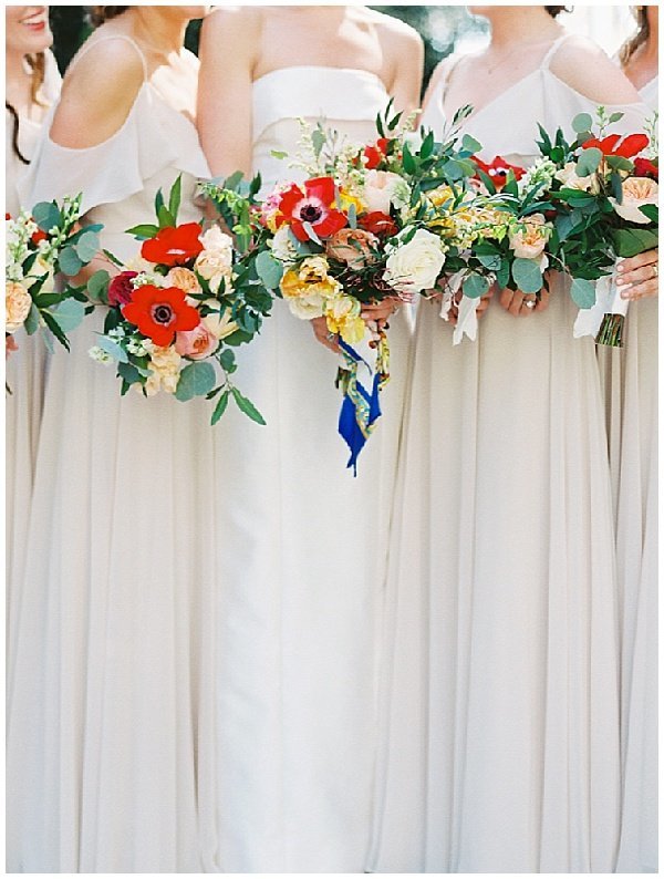 Long Cream Bridesmaid Dresses with Red and Yellow Bouquets with Red Anemones © Bonnie Sen Photography