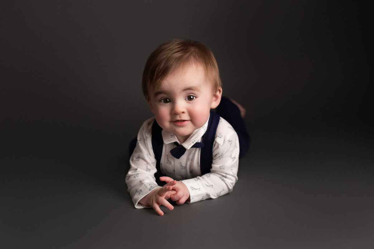 Six month baby dressed in smart shirt & bowtie