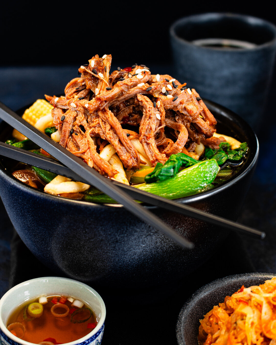 bowl of pulled Teriyaki beef with Udon noodles, kimchi and dipping sauce