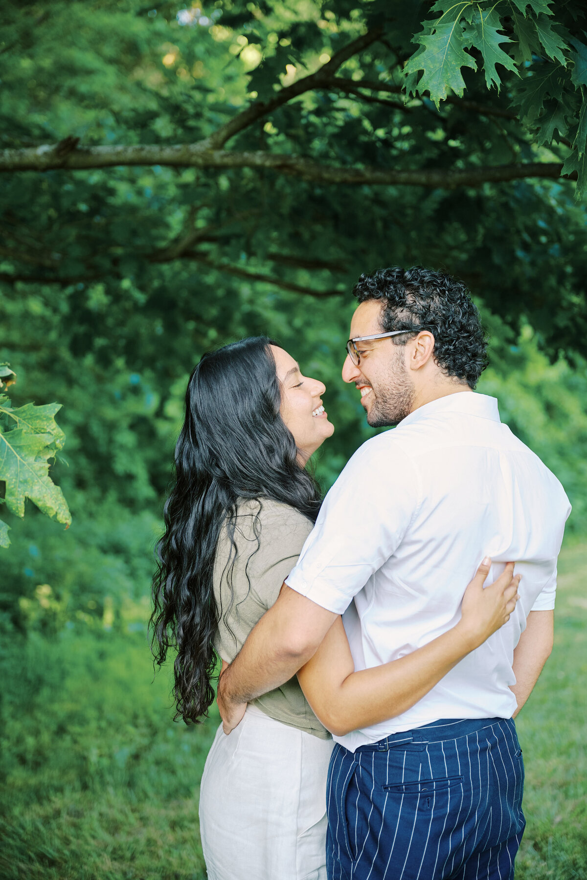 Couple stand face to face smiling after a successful New York City Picnic Proposal.  Photo taken by NYC Proposal Photographer, Corey Lamar Photography