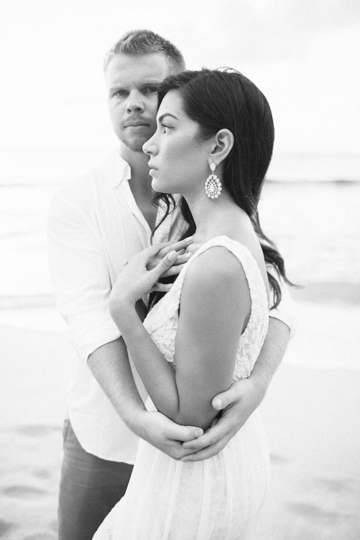 GroomEmbracingBrideSunsetBeachOahu