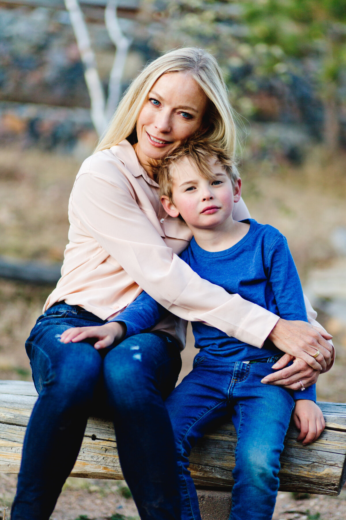 a mom in pink hugs her son in blue