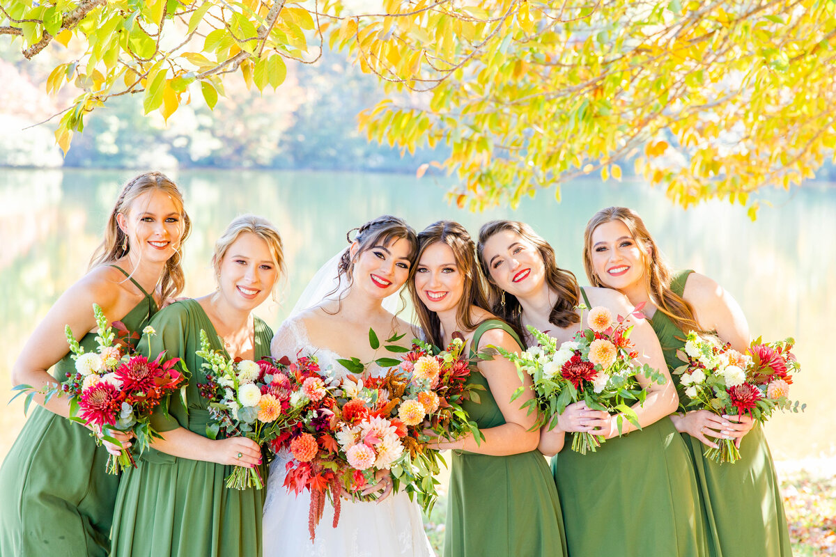 bride surrounded by bridesmaids in green dresses